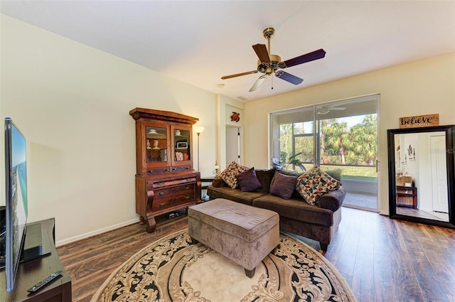 living room featuring ceiling fan and dark hardwood / wood-style flooring