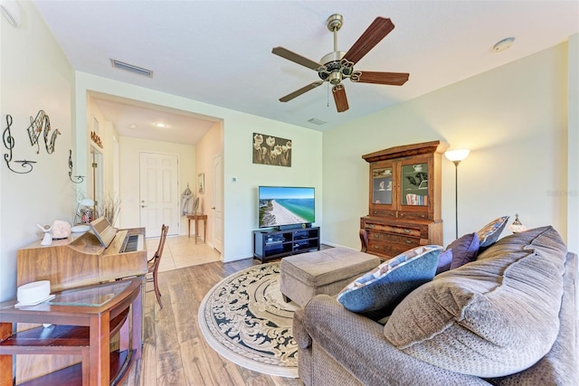 living room with ceiling fan and light wood-type flooring