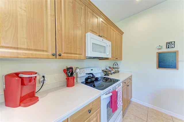 kitchen with light tile patterned flooring and white appliances