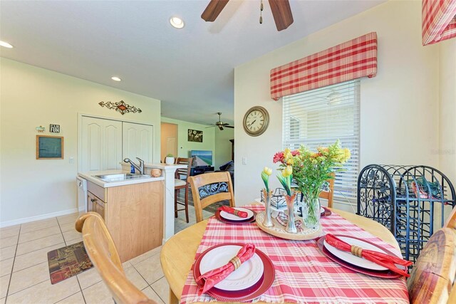 dining area with ceiling fan, light tile patterned flooring, and sink