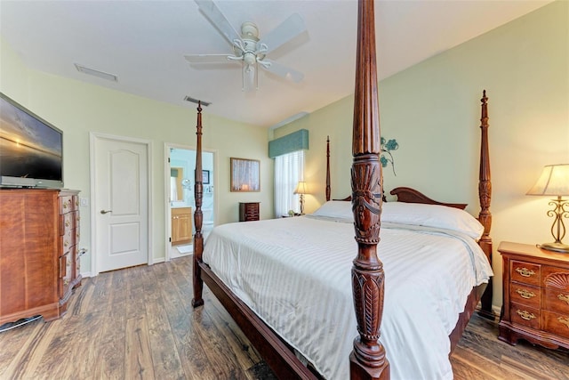 bedroom with ensuite bath, ceiling fan, and dark hardwood / wood-style floors