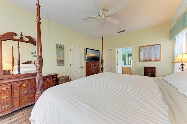 bedroom with connected bathroom, ceiling fan, and wood-type flooring