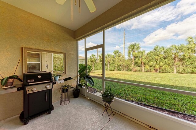 sunroom / solarium featuring ceiling fan