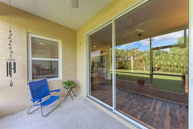 sunroom / solarium featuring ceiling fan