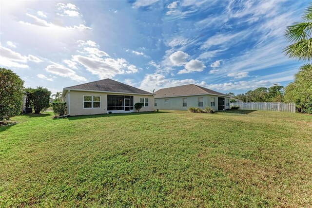 back of house featuring a yard