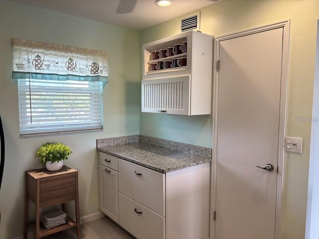 kitchen with white cabinets and light stone countertops