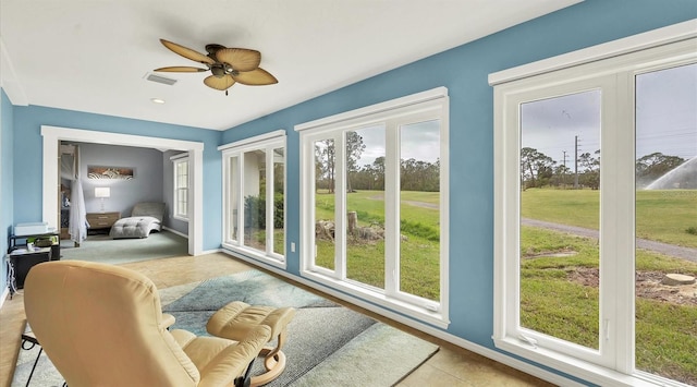 sunroom with a wealth of natural light and ceiling fan