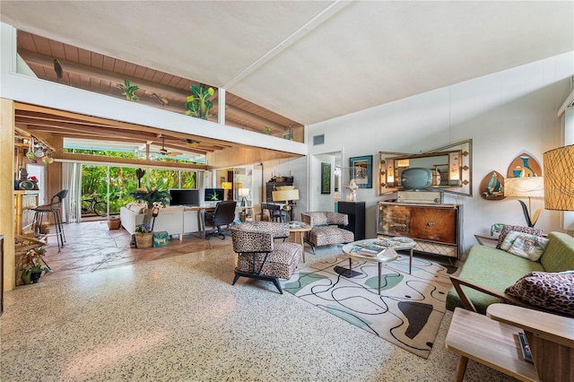 living room featuring vaulted ceiling with beams