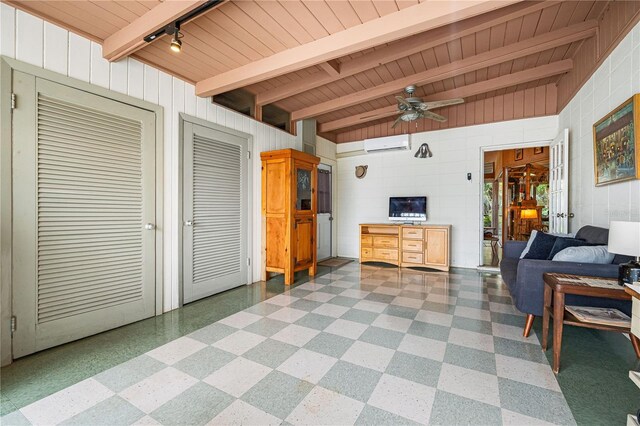 living room featuring ceiling fan, a wall mounted AC, rail lighting, beam ceiling, and wood ceiling