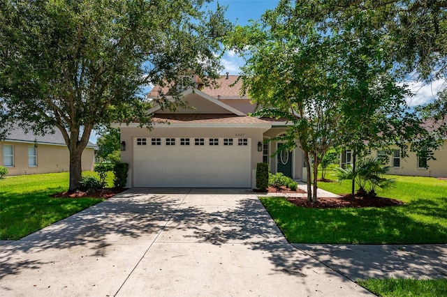 view of front of home featuring a garage and a front lawn