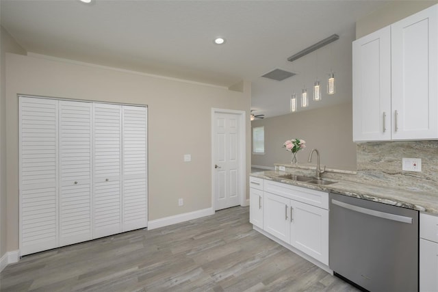 kitchen with stainless steel dishwasher, white cabinets, sink, and light hardwood / wood-style flooring