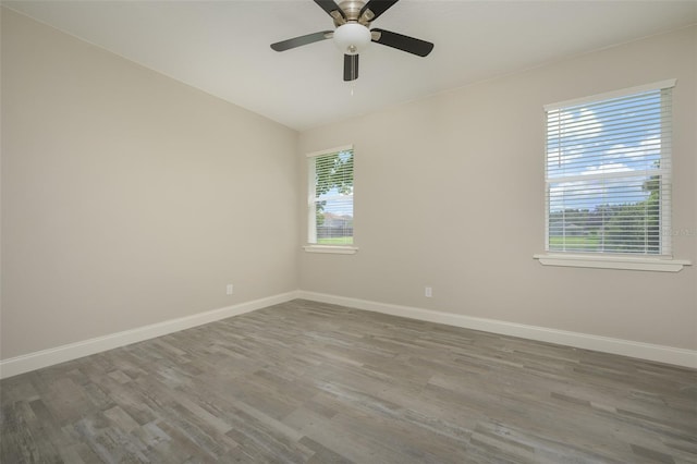 unfurnished room featuring ceiling fan, wood-type flooring, and vaulted ceiling