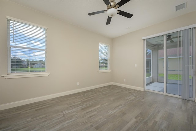 empty room with hardwood / wood-style floors and ceiling fan