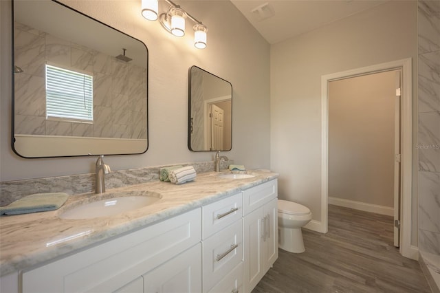 bathroom with hardwood / wood-style floors, vanity, and toilet