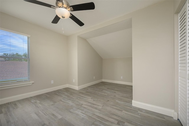 additional living space with light wood-type flooring, vaulted ceiling, and ceiling fan