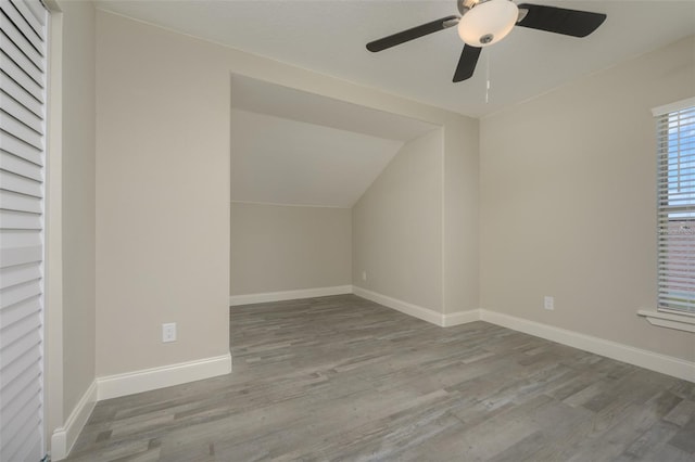 additional living space with light wood-type flooring, vaulted ceiling, and ceiling fan