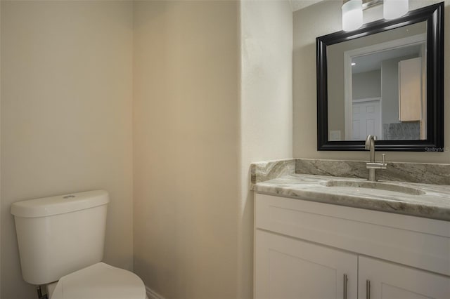 bathroom featuring toilet and vanity