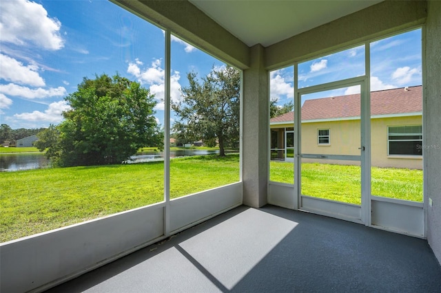 unfurnished sunroom with a water view