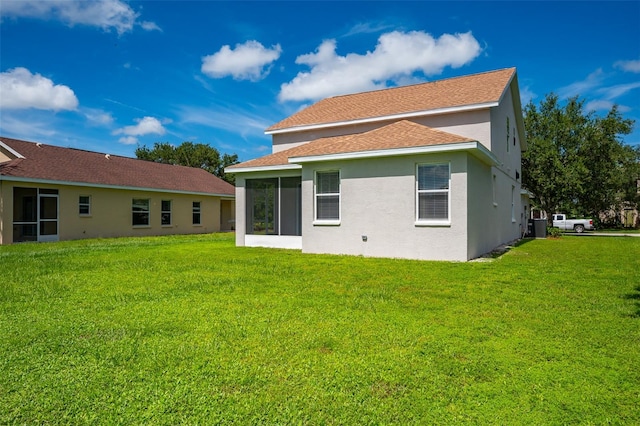 back of property featuring a lawn