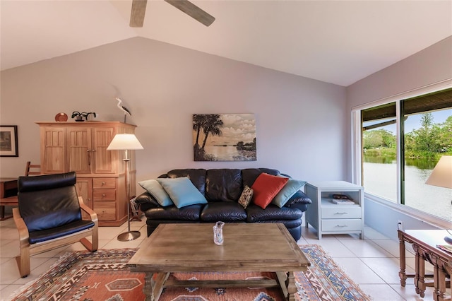 living room featuring ceiling fan, lofted ceiling, and light tile patterned flooring