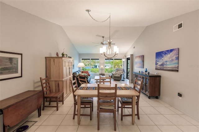 tiled dining room featuring lofted ceiling and an inviting chandelier