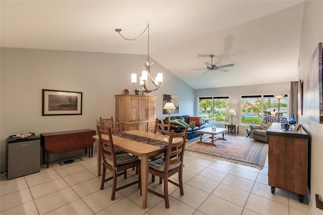 tiled dining area featuring high vaulted ceiling and ceiling fan with notable chandelier