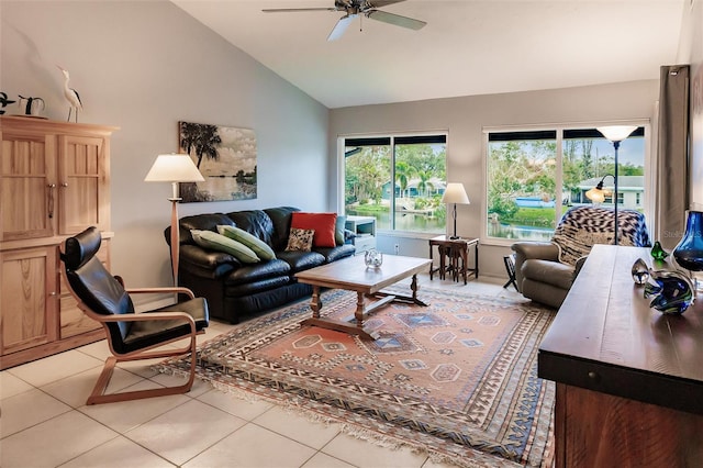 living room with lofted ceiling, light tile patterned flooring, and ceiling fan