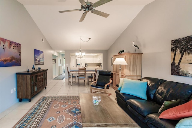 living room with high vaulted ceiling, light tile patterned floors, and ceiling fan with notable chandelier