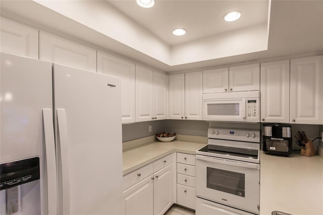 kitchen with white cabinetry and white appliances