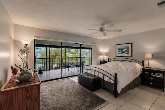 bedroom featuring ceiling fan, light tile patterned floors, and access to outside