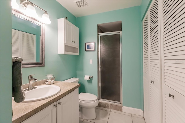 bathroom featuring toilet, walk in shower, tile patterned floors, and vanity