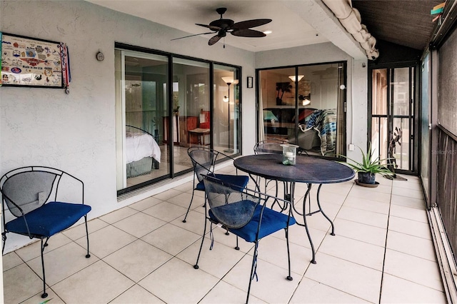 sunroom with baseboard heating and ceiling fan