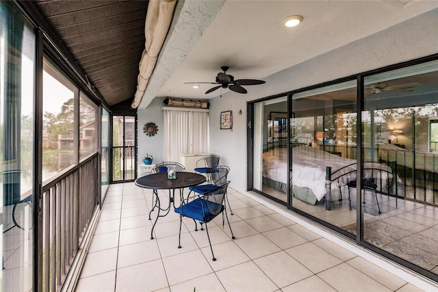 sunroom / solarium with beamed ceiling and ceiling fan