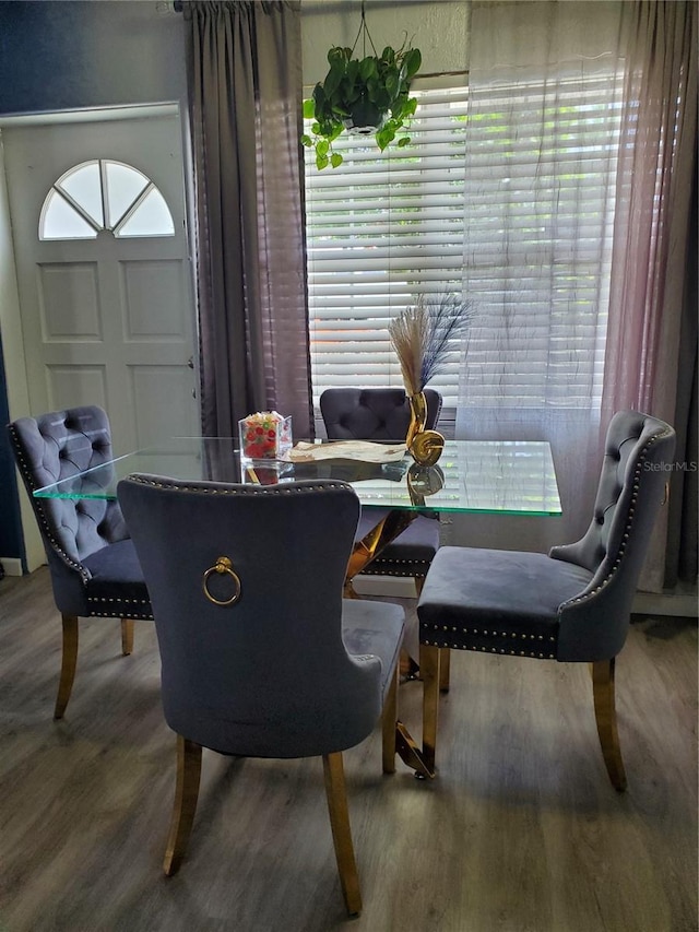 dining room with hardwood / wood-style flooring and a healthy amount of sunlight