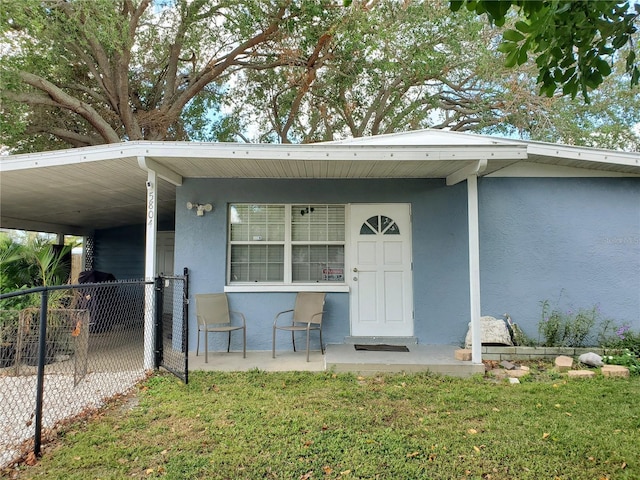 view of exterior entry with a yard