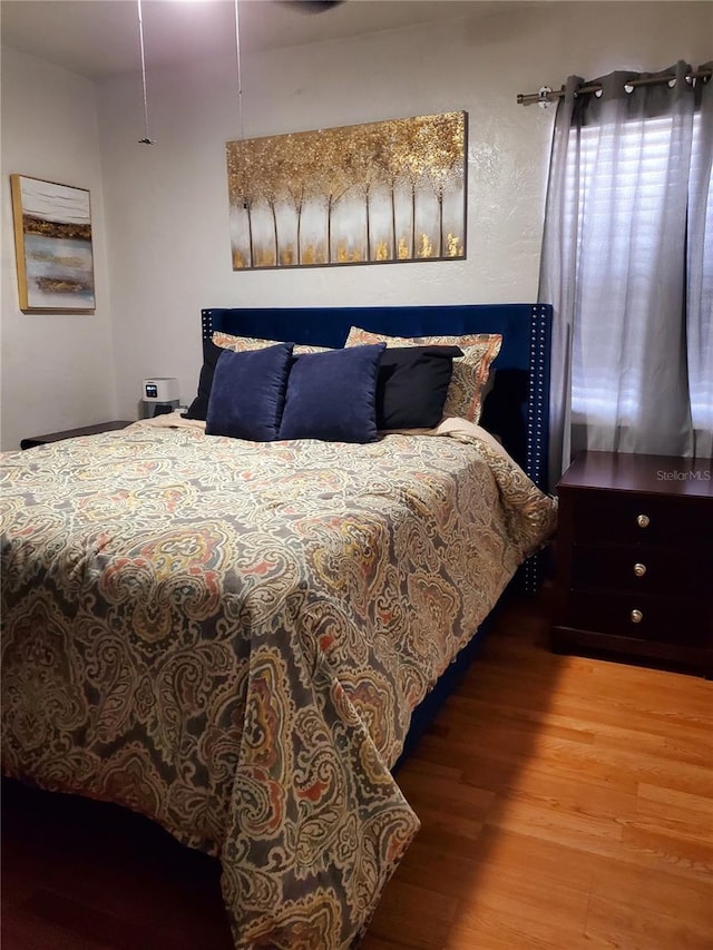 bedroom with hardwood / wood-style floors