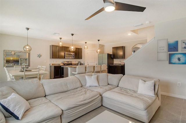 living room with ceiling fan and light tile patterned floors