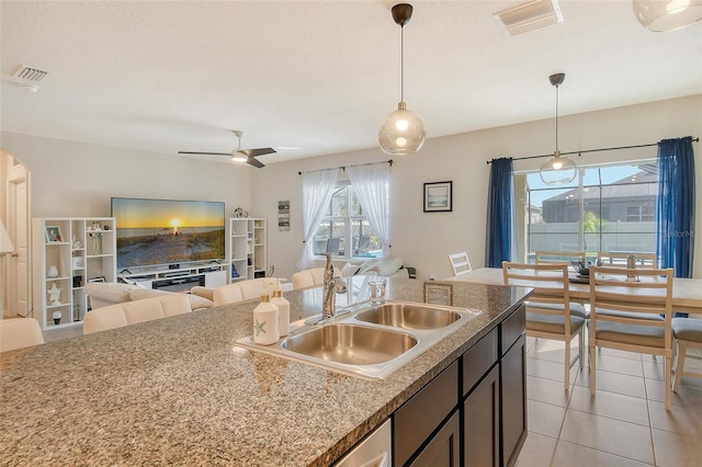 kitchen featuring pendant lighting, sink, light tile patterned floors, and plenty of natural light