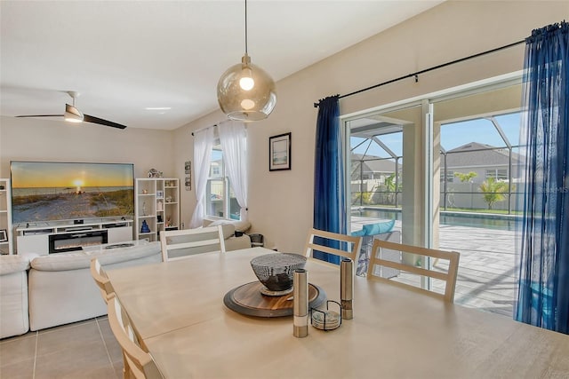 tiled dining space with ceiling fan