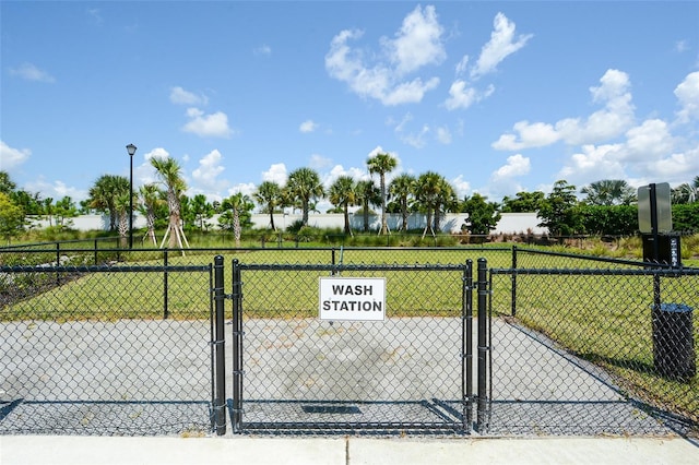 view of gate featuring a lawn