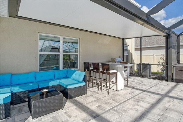 view of patio / terrace featuring an outdoor bar, a lanai, and an outdoor hangout area