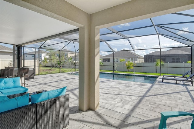 view of swimming pool with a patio, a lawn, and glass enclosure