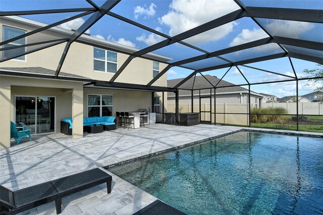 view of swimming pool with glass enclosure and a patio area