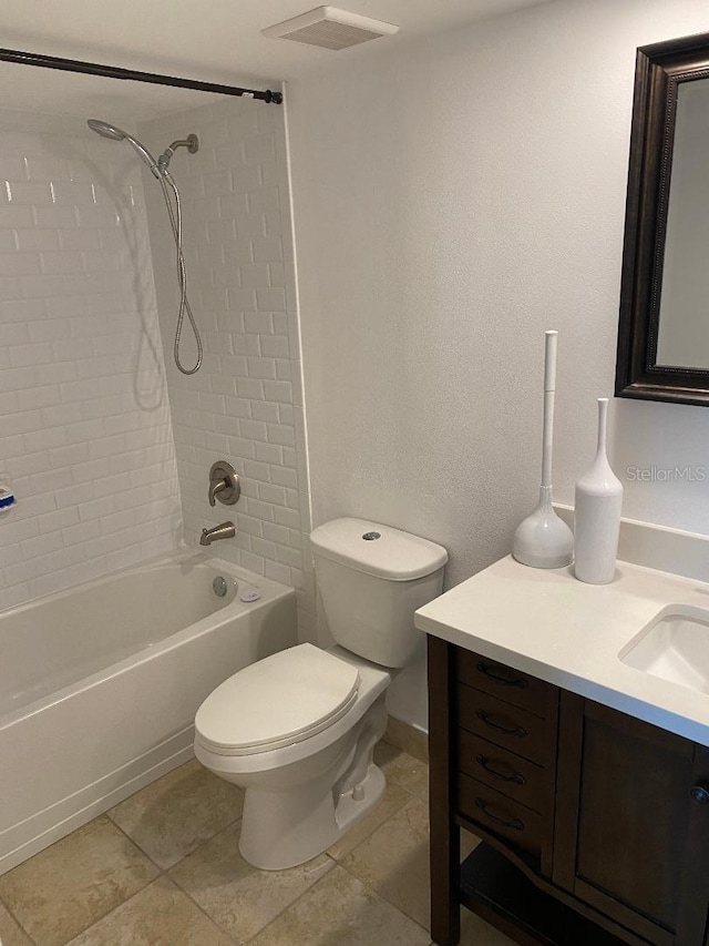 full bathroom with tile patterned flooring, vanity, toilet, and tiled shower / bath combo