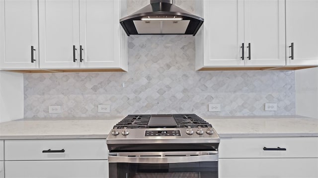 kitchen featuring white cabinets, extractor fan, and stainless steel range with gas stovetop