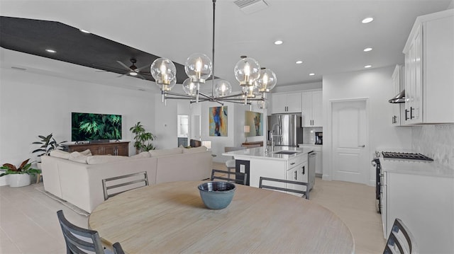 tiled dining room featuring ceiling fan and sink