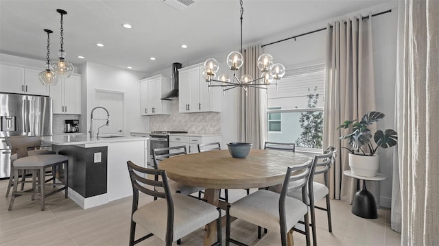 tiled dining room featuring sink and an inviting chandelier