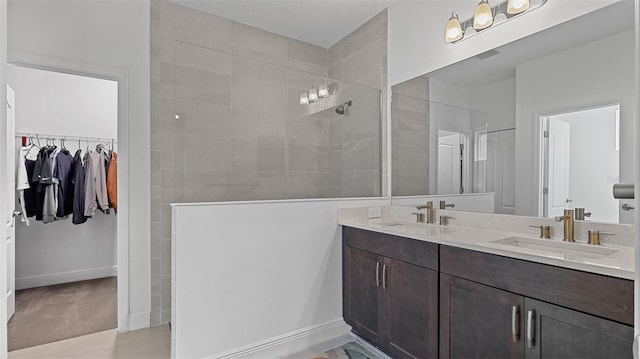 bathroom featuring vanity and tiled shower