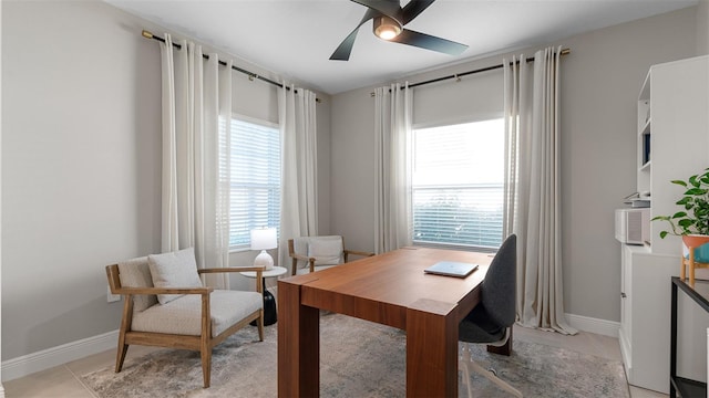 home office featuring ceiling fan and light tile patterned floors