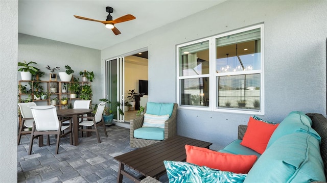 sunroom / solarium featuring ceiling fan